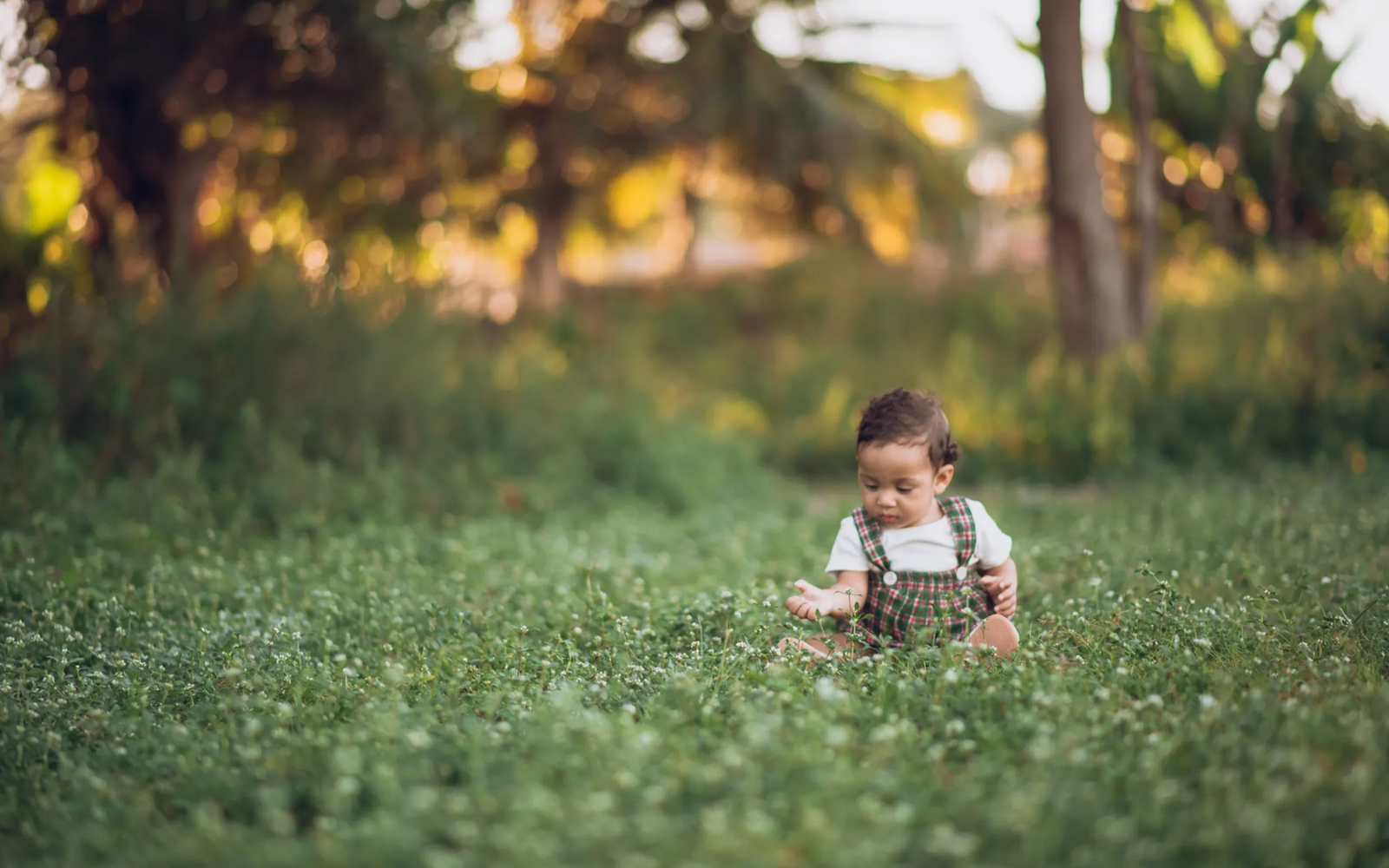 Baby playing with wooden toys outdoors as part of analog parenting and screen-free play
