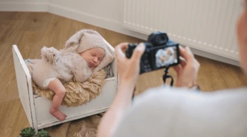 Baby dressed in a soft smocked romper for a photoshoot