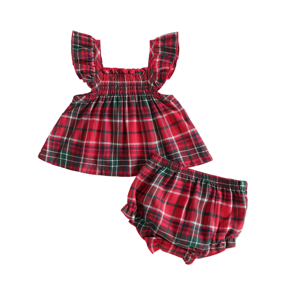 A baby girl's two-piece holiday outfit set featuring a red and green plaid smocked dress with ruffled sleeves and matching plaid bloomers, styled on a beige background with Christmas decorations.

